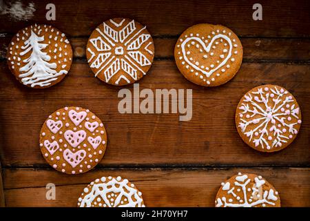 Christmas cookies with icing on wooden background Stock Photo