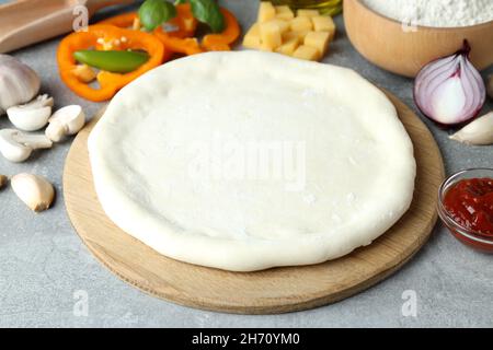 Concept of cooking pizza on gray textured background Stock Photo