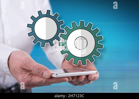 Setting concept above a smartphone held by hands Stock Photo