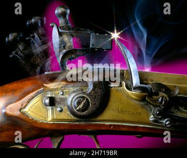 Close up of firing mechanism of Flintlock pistol & microchip as a flint on graduated purple & black background starburst spark W Ketland Stock Photo