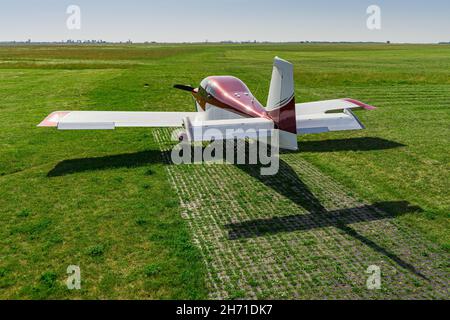 Small modern private jet before the flight against the backdrop of nature. Stock Photo