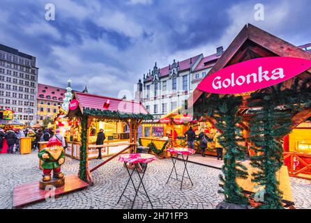 Wroclaw, Poland - December 2019: Traditional winter polish Christmas Market in medieval Rynek Marquet Square. New Year ambiance, illuminated ornamente Stock Photo