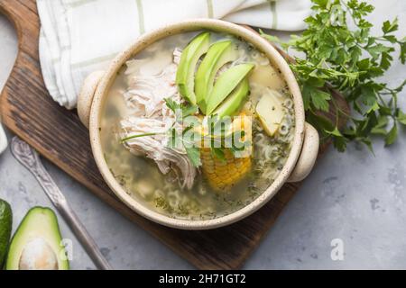 Traditional Ajiaco Colombiano - Colombian Soup with potato, chicken, avocado Stock Photo