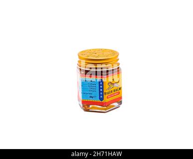 Norwich, Norfolk, UK – November 15 2021. A glass jar of Tiger Balm muscle rub cut out isolated on a plain white background Stock Photo