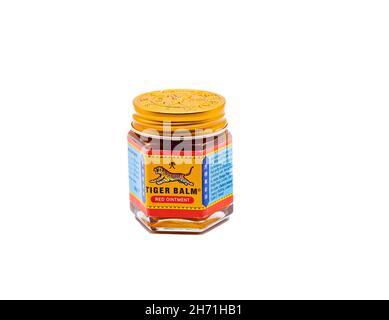 Norwich, Norfolk, UK – November 15 2021. A glass jar of Tiger Balm muscle rub cut out isolated on a plain white background Stock Photo