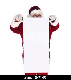 Santa Claus holding a blank scroll in front of his body. Santa is looking over the top of the long roll of paper. Stock Photo