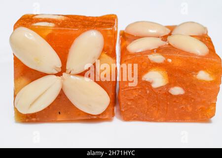 Karachi Halwa a form of Bombay halwa is Indian Pakistani sweet dish item. Orange in colour made of cornflour, sugar, water. Eaten and served during fe Stock Photo