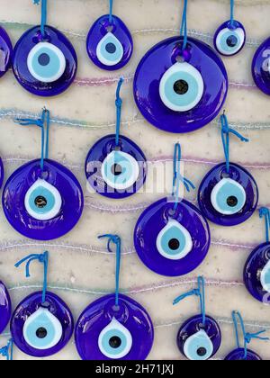 Turkish Evil Eye beads on the wall. Stock Photo
