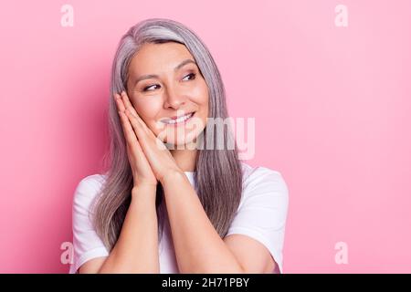 Portrait of attractive dreamy cheerful grey-haired woman resting isolated over pink pastel color background Stock Photo