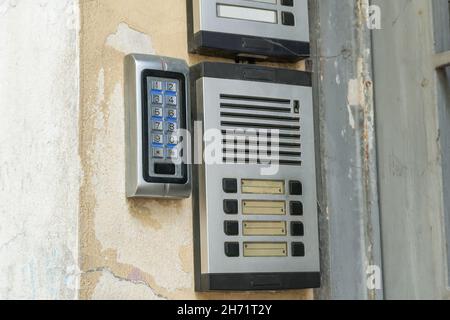 Old-fashioned vintage doorbells with blank nameplates. An outdoor intercom outside a residential building with empty name cards. Stock Photo