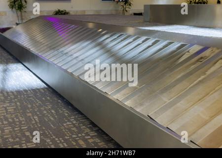 Baggage claim area with conveyor belt in arrivals lounge of airport terminal Stock Photo