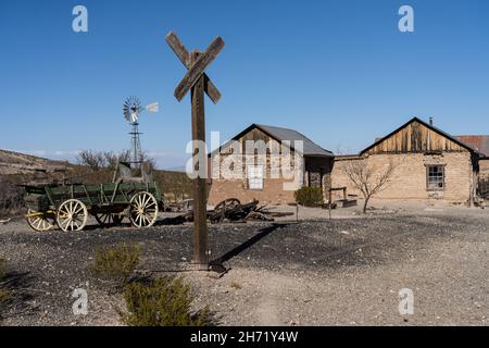 The old mine railroad crossing in the ghost town of Shakespeare, New Mexico.  Behind is the saloon and stagecoach station. Stock Photo