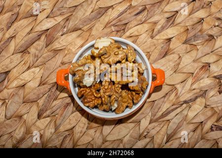 Walnuts, a handful of peeled walnuts on a plate Stock Photo