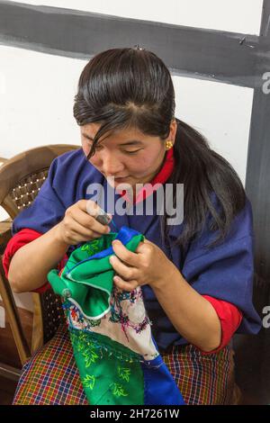 A sewing student in the National Institute of the Thirteen Arts learns embroidery in Thimphu, Bhutan.