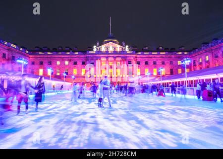 London, UK. 19th Nov, 2021. People enjoy ice skating in the courtyard of the historic Somerset House buildings. The SKATE ice rink at the beautifully illuminated Somerset House in Central London once again welcomes visitors to skate and socialise at its ice rink and indoor/outdoor bars from this week. Credit: Imageplotter/Alamy Live News Stock Photo