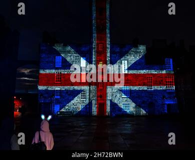Edinburgh Castle, Scotland, UK, 19th November 2021. Castle of Light: Edinburgh Castle's Christmas light show opens tonight and gives visitors a history of the castle in projected images on its walls. Pictured: a Union Jack flag projected onto a building Stock Photo