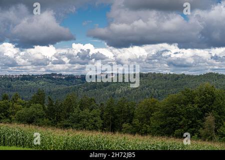 Small village on a hill in the middle of the forest and a field of corn Stock Photo