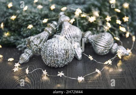 Christmas ornaments and festive lights on dark background Stock Photo