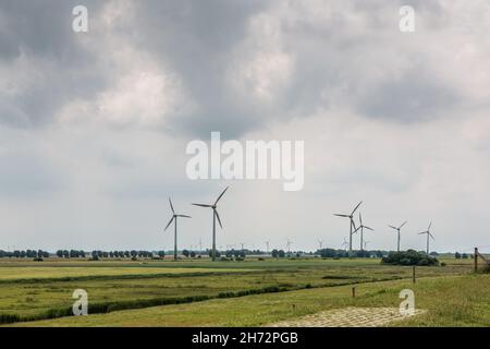 Wind wheels for renewble energy on the flat marshland of North Germany Stock Photo