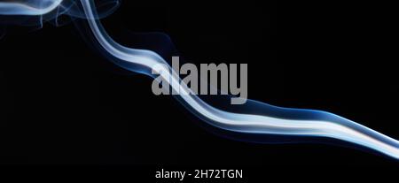 blue smoke on black background with abstract blur motion wave swirl . Wisp of Smoke. Cigarette smoke waves and clouds  texture Stock Photo