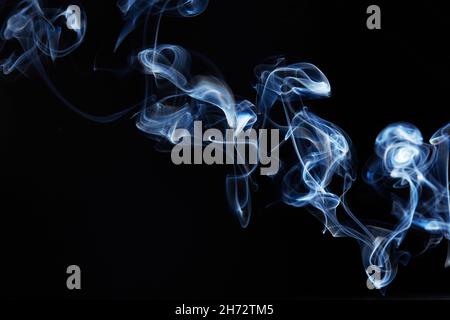 blue smoke on black background with abstract blur motion wave swirl . Wisp of Smoke. Cigarette smoke waves and clouds  texture Stock Photo