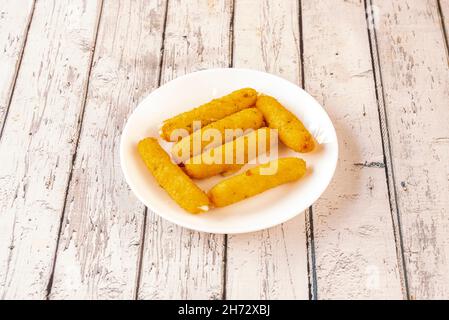 Mozzarella sticks are long pieces of mozzarella cheese that are battered or breaded and fried. Often served in restaurants as an aperitif Stock Photo