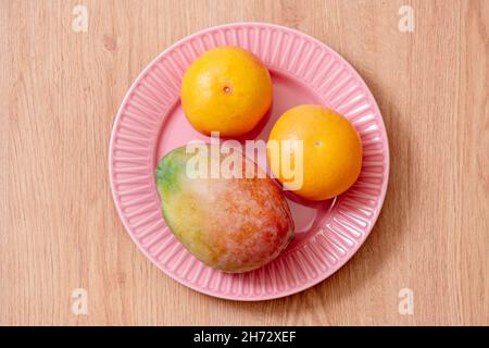 The mango is the name of the fruits of several species of trees of the genus Mangiferalanta and of the genus Citrus, of the family of Rutaceae, cultiv Stock Photo