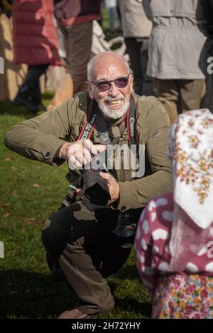 October 1, 2016, Moscow. Cossack gathering. gray-haired elderly photographer smiles cheerfully with a camera in his hand. cheerful old photographer wi Stock Photo
