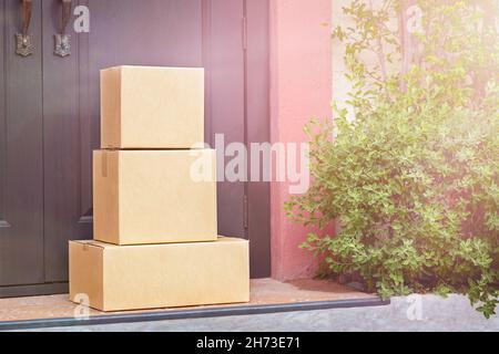 Cardboard boxes are on the porch in front of the door Stock Photo