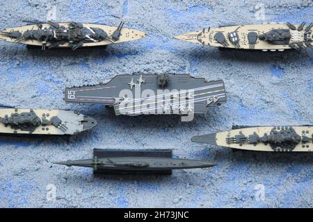 The lineup of miniature battleships consists of the enterprise carrier, the submarine, the battleship Musashi, the battleship Yamato Stock Photo