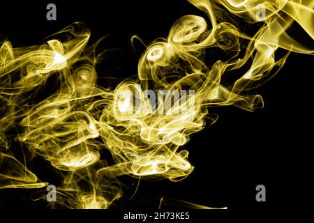 Yellow color abstract smoke on black background Stock Photo