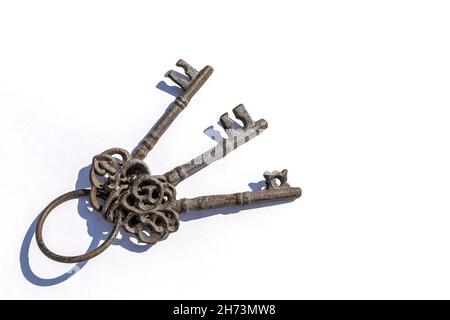 Three old antique metal keys on white background Stock Photo