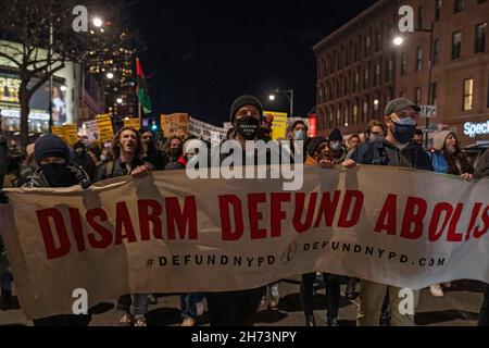 New York, USA. 19th Nov, 2021. Protestors hold a banner calling to abolish the police during a protest march in Brooklyn against the acquittal of Kyle Rittenhouse in New York City.Hundreds march through Brooklyn to protest Rittenhouse verdict and calling his acquittal a double standard and a failure of the justice system. Kyle Rittenhouse (18) faced homicide charges and other offenses in the fatal shootings of Joseph Rosenbaum and Anthony Huber and for shooting and wounding of Gaige Grosskreutz during unrest in Kenosha that followed the police shooting of Jacob Blake in August 2020. Credit: SO Stock Photo