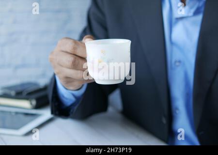 businessman drinking tea while sited  Stock Photo