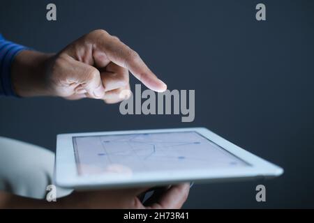 analyzing stock market data on digital tablet  Stock Photo
