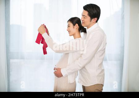 Young couple and baby clothes Stock Photo