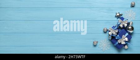 Beautiful Christmas gifts and decorations on blue wooden background with space for text Stock Photo