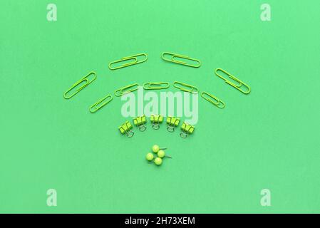 WiFi symbol made from paper clips on green background Stock Photo