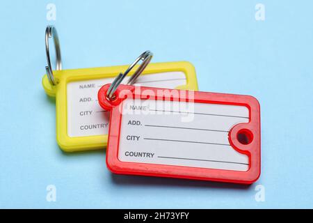Plastic key tags on blue background Stock Photo