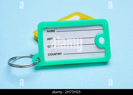 Plastic key tags on blue background Stock Photo