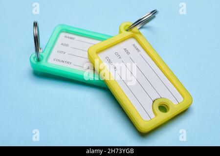 Plastic key tags on blue background Stock Photo