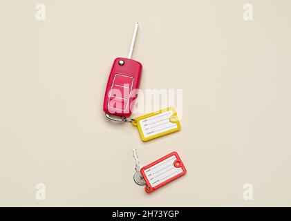 Keys with plastic tags on beige background, top view Stock Photo