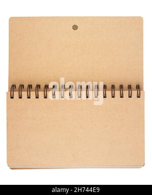 top view closeup of open notebook with metal spirals and light brown cardboard hardcover blank pages isolated on white Stock Photo