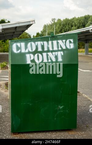 A green clothing deposit container or bank in a car park Stock Photo