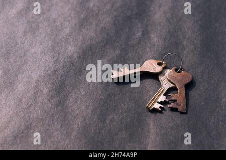 Bunch of old House Key isolated on a rustic Floor. High Angle View. Copy space room for text. Safety secure protection background concept. Stock Photo