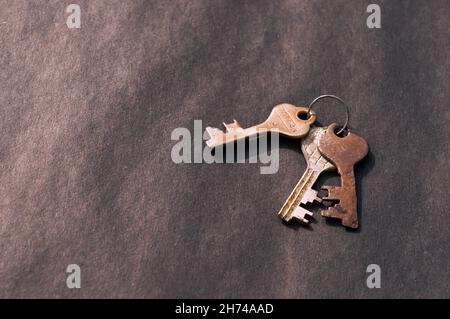Bunch of old House Key isolated on a rustic Floor. High Angle View. Copy space room for text. Safety secure protection background concept. Stock Photo