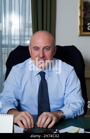 02-15-2007 . Moscow Russia. The rich man Milner Yuri is talking on the phone in his office. Behind him is a Turner paintingюThe walls of the Kremlin a Stock Photo