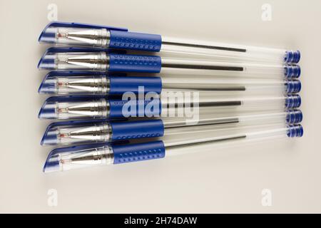set of blue ballpoint pens lined up hardly on a white background Stock ...