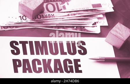 paper note with stimulus package Message, pen and money. Business social Concept Stock Photo
