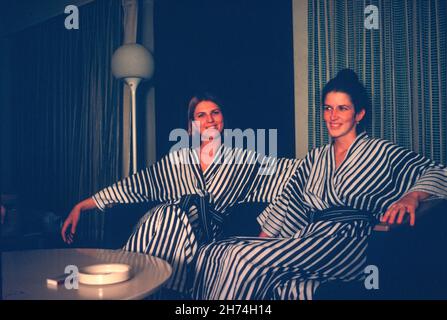 Two Pan Am Stewardesses Relax in Hotel Robes at the Keio Plaza Hotel, Tokyo, Japan, 1970's Stock Photo